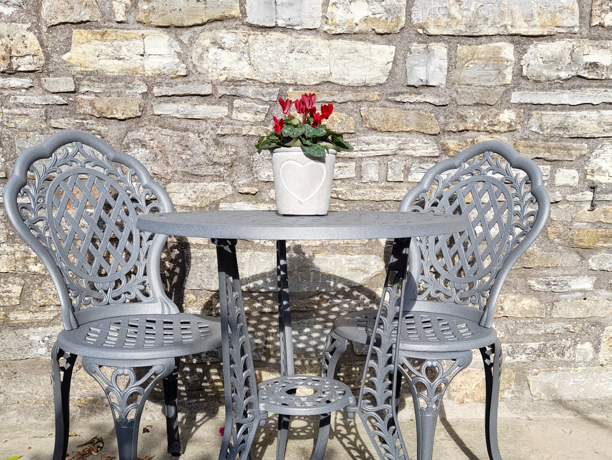 Create an intimate outdoor space with a garden bistro table and chairs