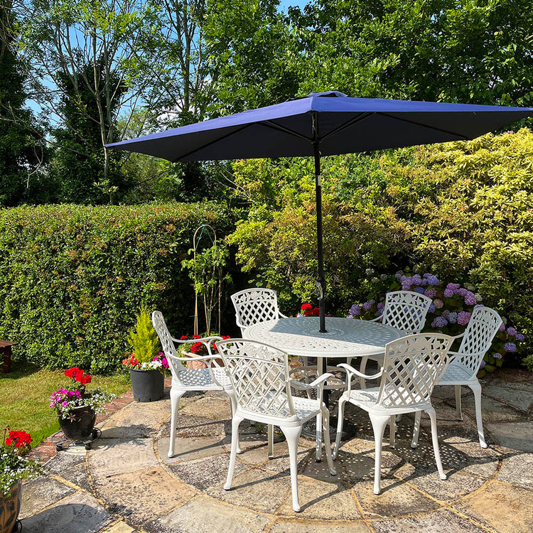 White outdoor 6 seater table and chairs set with blue parasol