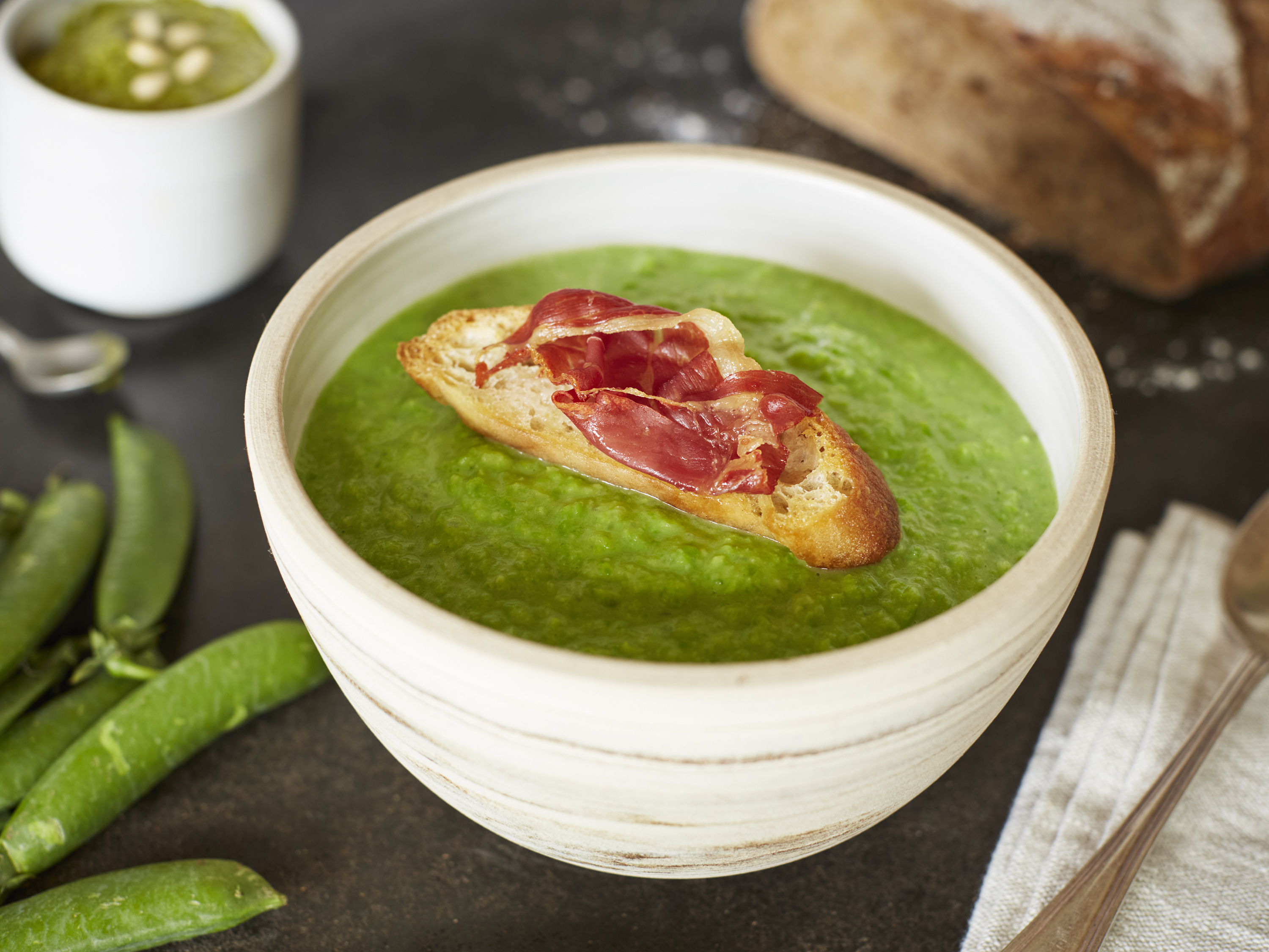 Chilled pea soup with Parma ham topped croûtons and homemade pesto